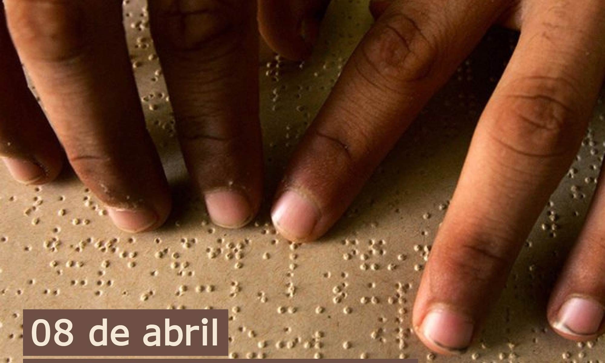 foto de duas mãos da mesma pessoa lendo um documento em Braile. Está escrito: "08 de abril dia nacional do Braile Abril Marrom 2021" e há a logo da Retina Brasil e a marca do Abril Marrom